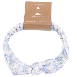Angel Dear Knot Headband in white and light blue floral print, featuring a front knot. Displayed on branded brown cardboard backing. A cozy accessory to complete any baby’s fall and winter outfits.