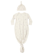 The Quincy Mae Baby Boys’ Knotted Baby Gown + Hat Set features a cream-colored gown and matching hat, both made from soft organic rib knit and adorned with a charming moons and stars pattern.
