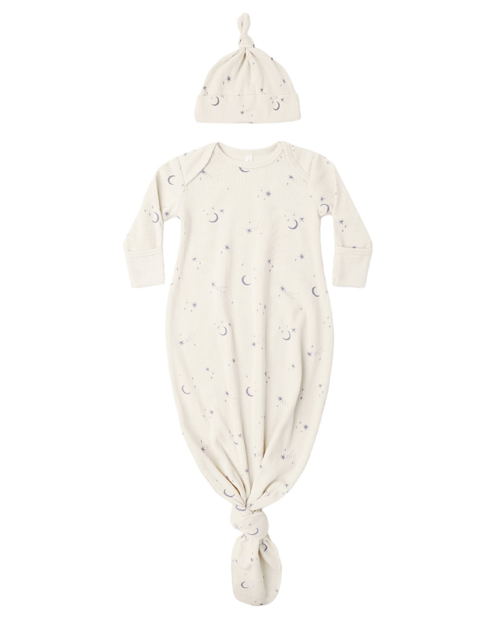 The Quincy Mae Baby Boys’ Knotted Baby Gown + Hat Set features a cream-colored gown and matching hat, both made from soft organic rib knit and adorned with a charming moons and stars pattern.