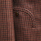 Close-up of the Moat Charmer Blazer by Blaze Milano: brown and red plaid pocket with curved seam and button accent, channeling power dressing.