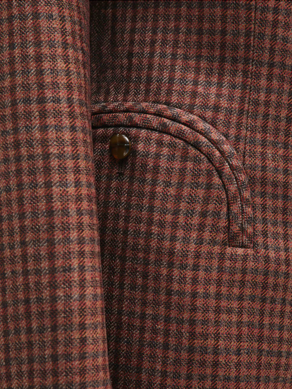 Close-up of the Moat Charmer Blazer by Blaze Milano: brown and red plaid pocket with curved seam and button accent, channeling power dressing.