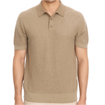 A person wearing the vince Geo Jacquard Shortsleeve Polo, a beige knit shirt with a collar and three buttons, stands against a plain white background.