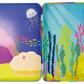 The Floss and Rock Ocean Magnetic Playtime Tin features a vibrant underwater scene with seaweed, rocks, fish, a jellyfish, and coral set against a blue background in an open magnetic tin. This set includes pop-out magnets made from recycled materials for interactive play.