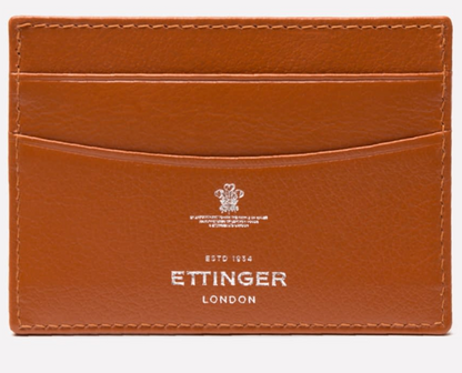 The Ettinger Capra Flat Credit Card Case is a tan leather cardholder with three card slots and an embossed logo on the front, offering minimalist style.