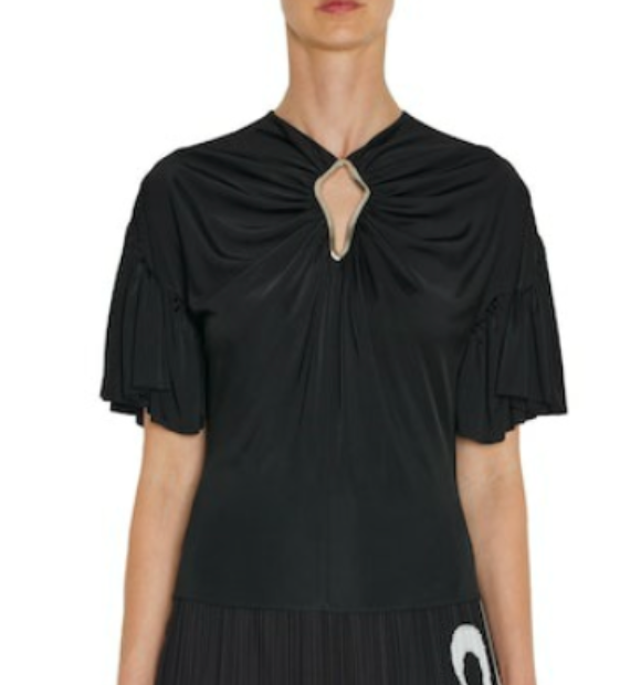 A person wearing Lanvin's Summer Top with Eyelet Detail, a black viscose jersey short-sleeve top featuring pleated sleeves and a diamond-shaped cutout at the neckline, as seen in the Winter 23 show.