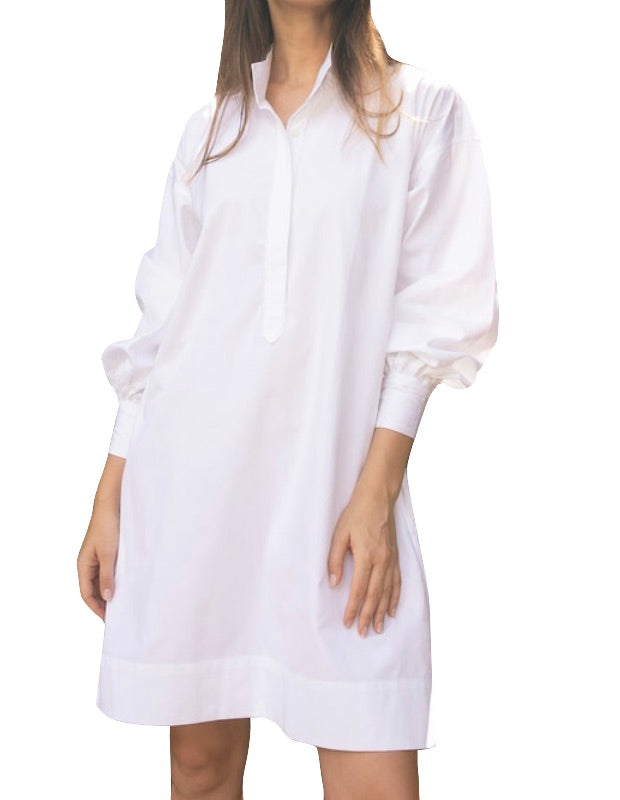 A woman wearing an Ann Mashburn Anaya Popover Dress, isolated on a white background.