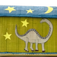 A Rice Raffia Toy Basket by the brand Rice, featuring a dinosaur illustration surrounded by stars and a crescent moon on a green background, crafted from natural materials reminiscent of handmade creations from Madagascar.