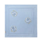 The Stella McCartney Kids Baby Knit Tennis Blanket is made of light blue organic cotton and features three embroidered cartoon-style circles with faces and yellow outlines, each in a unique playful pose on a plain background.
