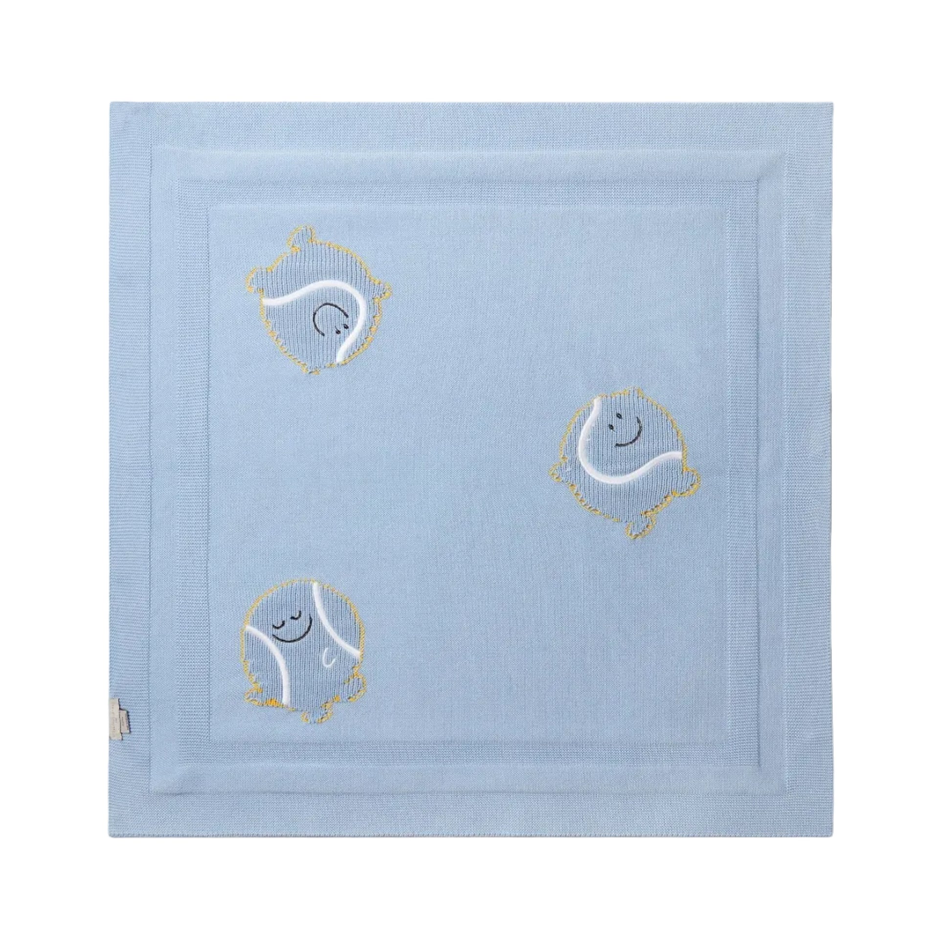 The Stella McCartney Kids Baby Knit Tennis Blanket is made of light blue organic cotton and features three embroidered cartoon-style circles with faces and yellow outlines, each in a unique playful pose on a plain background.