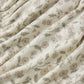 Close-up of the Quincy Mae Baby Girls’ Gathered Bloomer, crafted from cream-colored fabric with a gathered texture and adorned with a delicate small floral print in muted pink, green, and beige—perfectly designed with elasticated leg openings for adorable comfort.