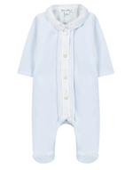 The Baby Boys’ Velvet Pointed Collar Pajamas by Tartine et Chocolat are light blue sleepwear featuring long sleeves, footed legs, a white button placket, and a decorative pointed collar. The garment is displayed flat against a white background.