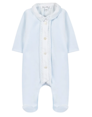 The Baby Boys’ Velvet Pointed Collar Pajamas by Tartine et Chocolat are light blue sleepwear featuring long sleeves, footed legs, a white button placket, and a decorative pointed collar. The garment is displayed flat against a white background.