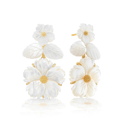 The Juliska Capucine De Wulf Mermaid Garden Convertible Floral Post Drop Earrings feature carved gold and white flowers with textured centers, adding a delicate, elegant touch to any outfit.