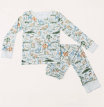 Timo & Violet Kids' The Two Piece Pajamas, made from organic cotton, feature long sleeves and a scenic Happy Monkey print with trees, animals, and water in soft pastel tones, shown laid flat on a white background.
