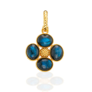 The Berry Clover Double Sided Pendant by Juliska Capucine De Wulf features four oval blue stones in a floral gold setting, a textured center, and twisted bail—an elegant lucky charm perfect for any occasion.