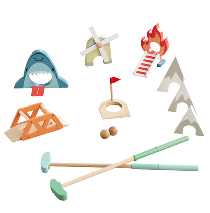 A variety of colorful miniature golf obstacles, including a shark, windmill, fire ramp, bridge, and two pyramids from the Asweets Putt Putt Golf Set by Asweets, along with two wooden putters are arranged in a circle.