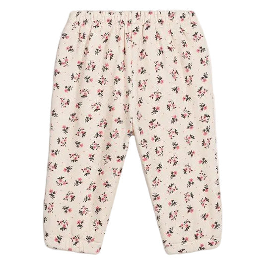 Louise Misha Girls’ Ysali Sweatpants in a cream hue feature an elasticated waist and are adorned with an allover pink and black floral print pattern. Delicate embroidery details add a charming touch to these cozy essentials.