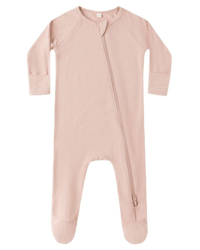 The Quincy Mae Baby Bamboo Zip Footie features a light pink color, long sleeves, footed legs, and an asymmetrical zipper running from neck to leg.