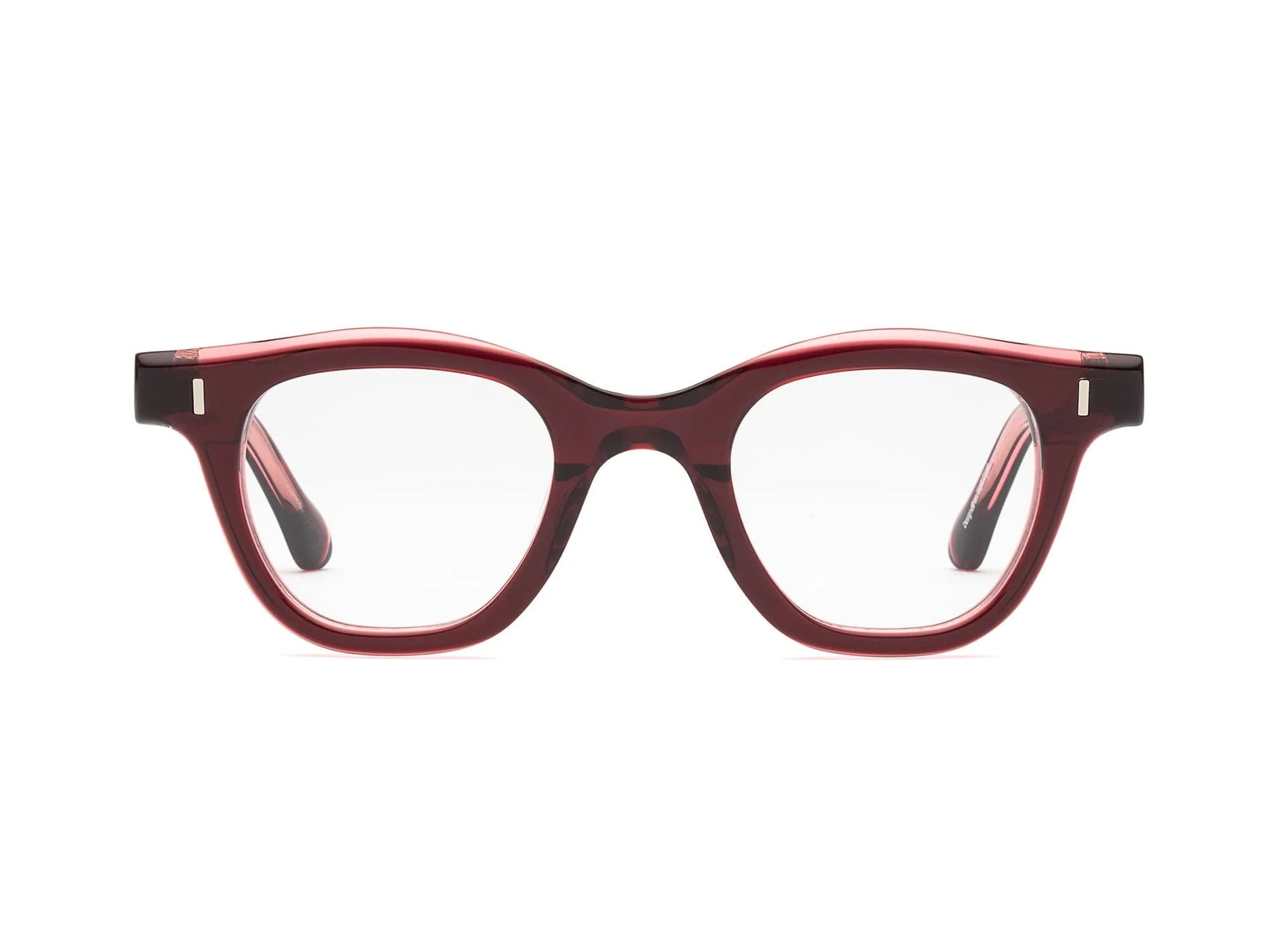 The Caddis Wabi Sabi eyeglasses feature a red tortoiseshell bio-based acetate frame and clear, scratch-resistant lenses, displayed front-facing on a white background.