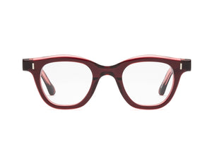 The Caddis Wabi Sabi eyeglasses feature a red tortoiseshell bio-based acetate frame and clear, scratch-resistant lenses, displayed front-facing on a white background.