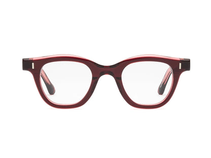 The Caddis Wabi Sabi eyeglasses feature a red tortoiseshell bio-based acetate frame and clear, scratch-resistant lenses, displayed front-facing on a white background.