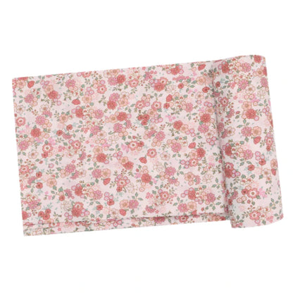 The Angel Dear Pretty Calico Swaddle Blanket, crafted by Angel Dear, is made from viscose derived from bamboo and showcases a delightful floral pattern in pink, red, and green on a light background. It's ideal for making soft, machine-washable swaddles.