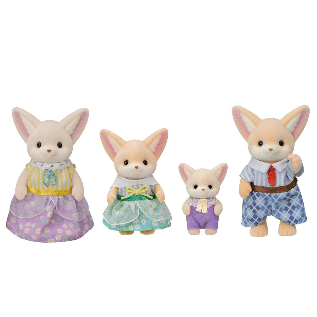 Four members of the Calico Critters Fennec Fox Family are standing in a row, wearing vibrant fabric outfits. The two larger figures stand at each end, while the two smaller figures are in the middle. Their removable clothing adds extra fun to playtime.