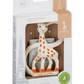 The boxed Teething Ring from Sophie la Girafe, suitable for 0+ months, is made of natural rubber with a giraffe design featuring orange spots. Its textured surfaces offer soothing relief, while the packaging includes an elegant Eiffel Tower illustration, making it perfect for babies.