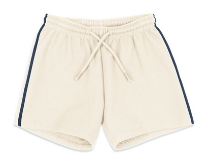Konges Slojd Baby Boys’ and Boys’ Florian Shorts in beige, featuring a drawstring waist and navy blue side stripes, crafted from organic cotton and displayed flat against a white background.