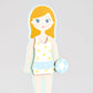 Illustration of the Elsie Magnetic Dress Up Character by Floss and Rock—a girl with blonde hair in a white and yellow floral swimsuit, holding a blue and white float, standing against a plain gray background—reminiscent of a magnetic dress up doll ready to showcase her summer style.