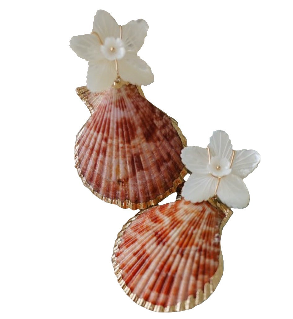 Introducing the Collected By Farrell La Mer Shell Earrings by Collected By Farrell, a unique piece adorned with small white flowers featuring mother of pearl centers and larger brown and white seashells attached.