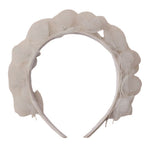 The Noralee Pixie Headband features layered translucent petals that create a floral design around the top, making it a magical finishing touch to any outfit.