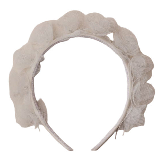 The Noralee Pixie Headband features layered translucent petals that create a floral design around the top, making it a magical finishing touch to any outfit.