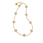 The Berry Clover Double Sided Necklace by Juliska Capucine De Wulf features a gold station chain with several evenly spaced, double-sided clover charms, each outlined in gold.