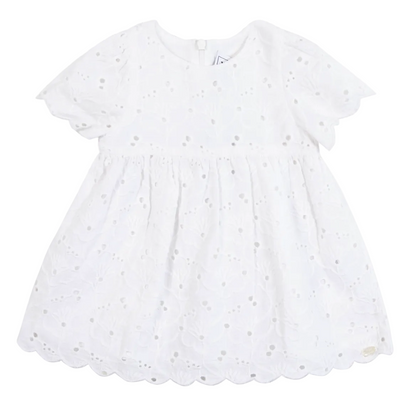 The Tartine et Chocolat Baby Girls’ and Girls’ English Embroidery Cotton Dress is a white, short-sleeve infant cotton dress with delicate eyelet embroidery, a scalloped hem, and a round neckline, featuring a convenient zip fastening. Shown against a plain white background.