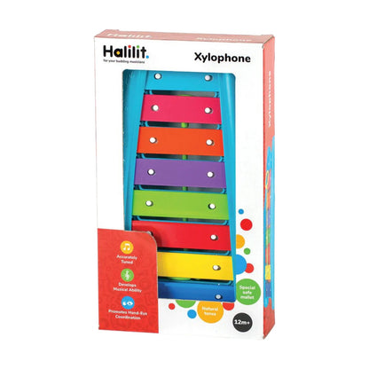 The Crocodile Creek Baby Xylophone comes in packaging and features eight vibrant metal bars with a wooden mallet. This engaging musical toy is designed for children aged 12 months and up.