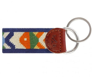 The Smathers & Branson Pompano Key Fob by Smathers & Branson features a multicolored, patterned fabric strip with brown leather trim, attached to two metal key rings. This stylish and vibrant accessory is designed to easily fit in your pocket while showcasing your colorful personality.