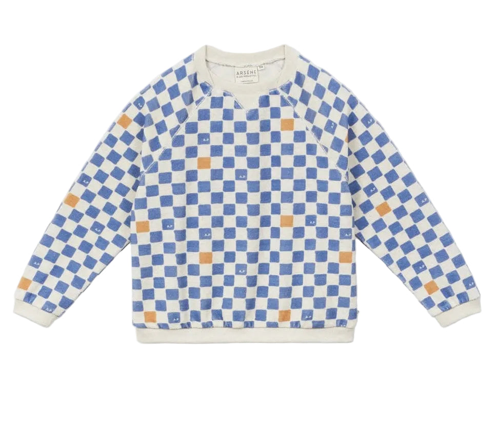 The Arsene & Les Pipelettes Boys' Checkered Terry Cloth Sweatshirt, featuring a blue and white checkerboard print with scattered orange squares, is shown laid flat on a white background.