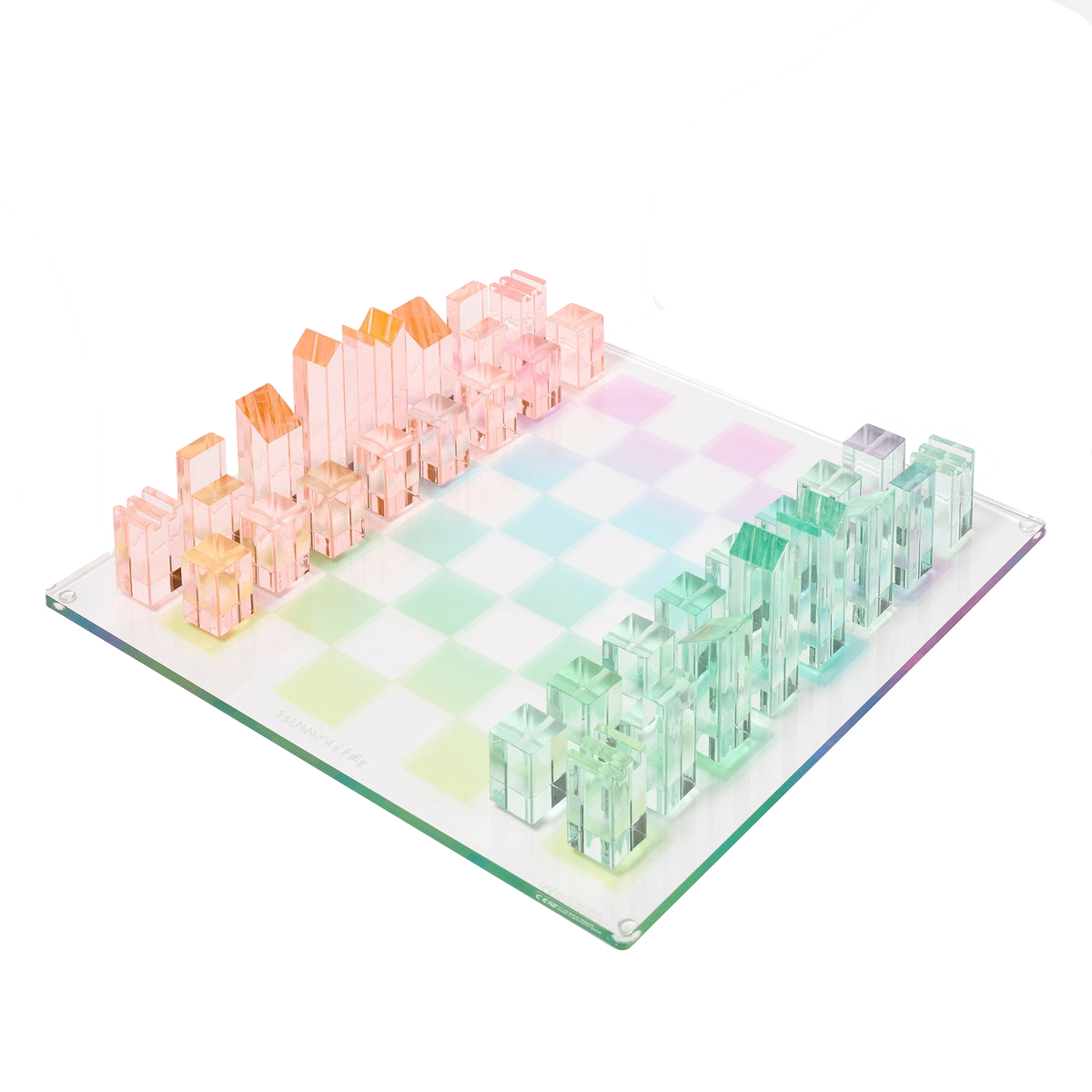 The Sunnylife Lucite Chess and Checkers, Aurora set by Sunnylife showcases a retro style with transparent pink and green pieces arranged on a pastel checkered board, exuding a kaleidoscopic color charm.