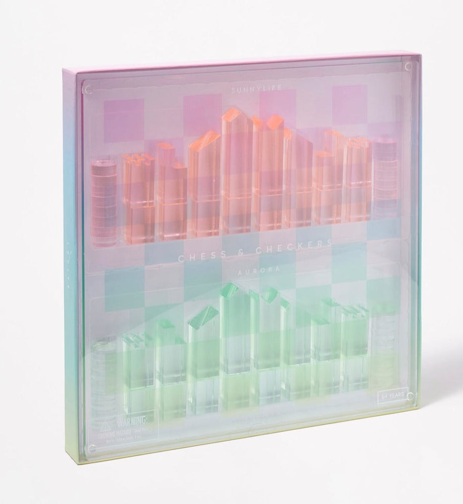 This retro-style set, the Sunnylife Lucite Chess and Checkers in Aurora, showcases pink and green pieces elegantly arranged in a pastel gradient box that echoes the kaleidoscopic hues characteristic of Lucite game sets.