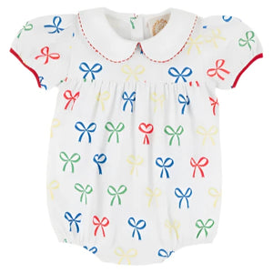 The Beaufort Bonnet Company's Baby Girls' Cindy Lou Bubble features a white design with a Peter Pan collar, red trim, and multicolored bow prints—perfect for adding charm to your little one's wardrobe.