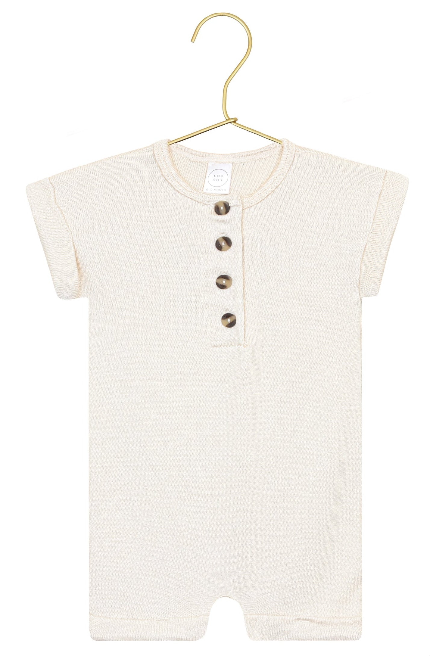 A cream-colored short-sleeve Baby Dakota Plush Knit Romper by Lou Lou & Company, featuring four dark buttons on the chest and displayed on a gold hanger against a white background. Perfect for everyday wear.