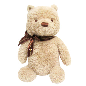 The Kids Preferred Classic Pooh Plush is a beige stuffed teddy bear with a brown nose and ribbon, sitting upright against a white background.