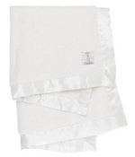 The Little Giraffe Luxe Baby Blanket, known for its ultra-soft feel and satin border, is neatly folded with a small embroidered logo on one corner.