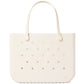 A beige, rectangular Original Bogg® Bag tote by Bogg Bags features rounded handles and small circular holes on its surface. The word “bogg” is embossed on the bottom right corner, making this washable bag ideal for use as a beach tote.