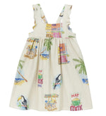The Girls' Cocos Frios Dress by Arsene & Les Pipelettes is a cream-colored sleeveless cotton twill dress featuring ruffled straps and vibrant tropical prints of toucans, palm trees, buildings, and carts—perfect for a stylish look.