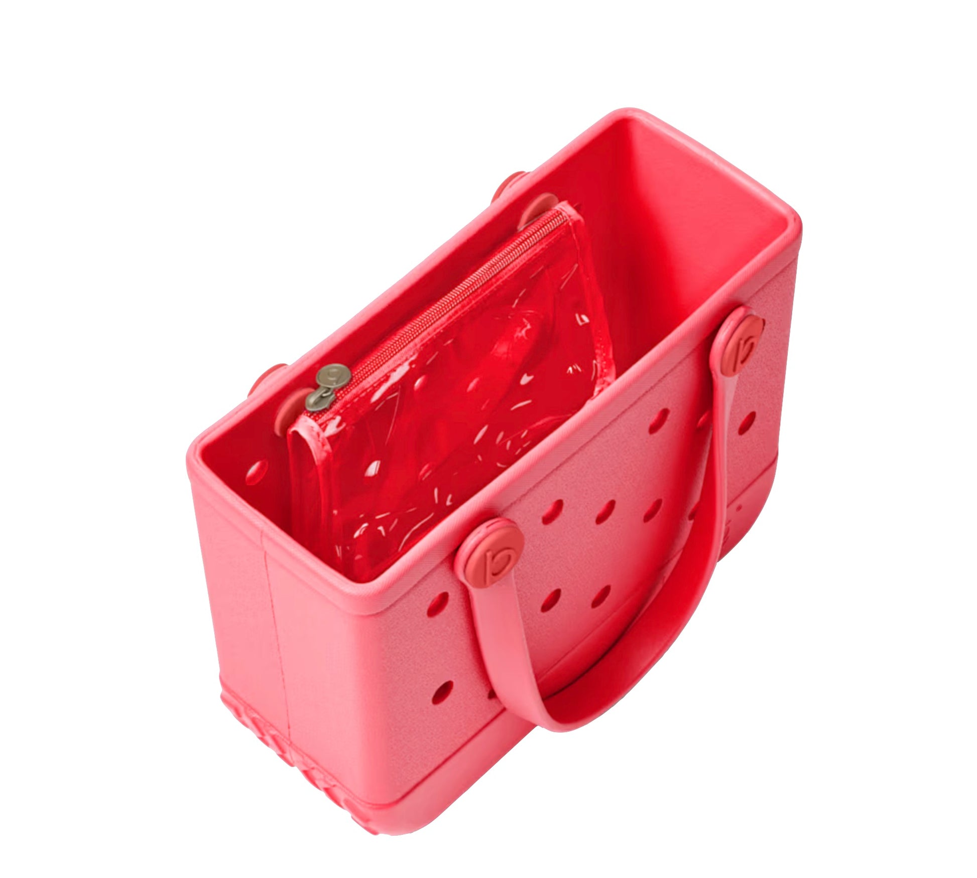 A rectangular pink Bitty Bogg® Bag by Bogg Bags, featuring signature holes and an included transparent zippered pouch, is displayed from an angled top view. This compact tote is ideal for organizing your essentials and can be easily washed for extra convenience.