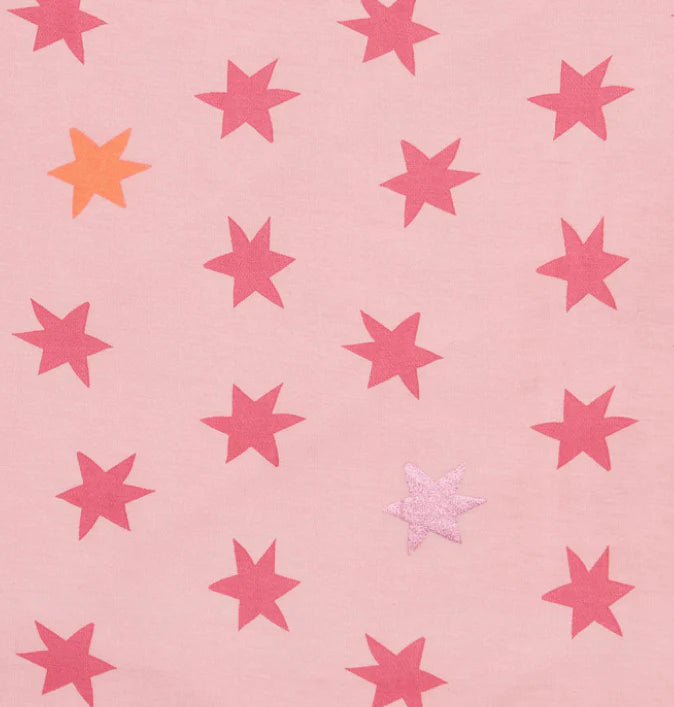 The Cosmic Confetti Baby Blanket by Magnetic Me features a pink background with red stars, plus one orange and one light pink glittery star—perfect as a temperature-regulating modal blanket for babies or strollers.
