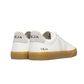 The VEJA Campo Leather Women's Sneakers in white, with beige accents and brown soles, are viewed from the back, prominently displaying the brand name "Veja" on the heel. Made in Brazil from ChromeFree leather, these stylish shoes offer added comfort and durability.