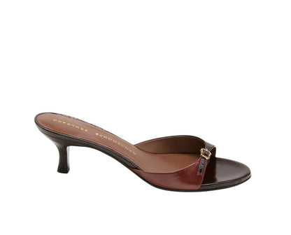 The Crackle Shine Kitten Heel by Dorothee Schumacher is a brown, open-toe crinkle patent leather sandal with a low kitten heel and a small signature buckle on the strap.